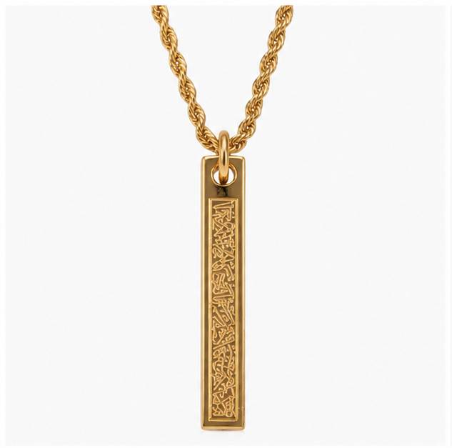Minimalist gold plated stainless steel vertical bar pendant necklace with detailed engraved calligraphy on a thick rope chain over a plain white background