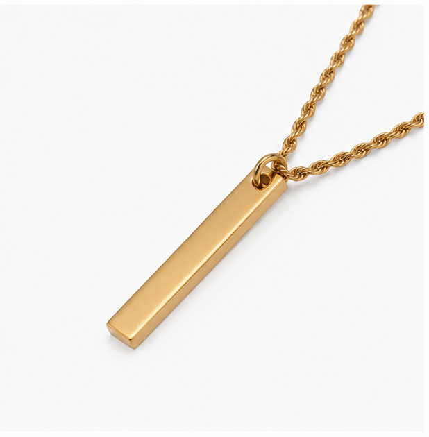 Reverse view of a minimalist solid gold custom bar tag pendant demonstrating a smooth plain unengraved backing.