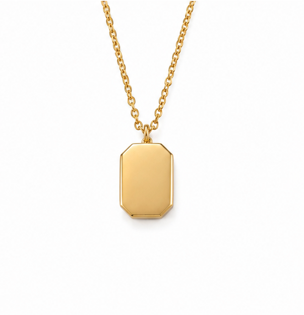 Reverse view of a gold initial style tag necklace showing a solid flat smooth gold back plate on a delicate chain.