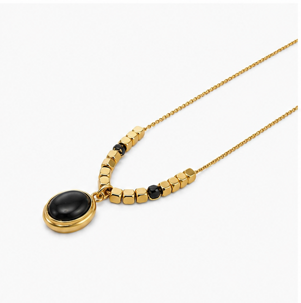 Zafiroon luxury 18k gold plated stainless steel necklace showcasing an oval black onyx pendant with golden cube beads on a plain white surface.