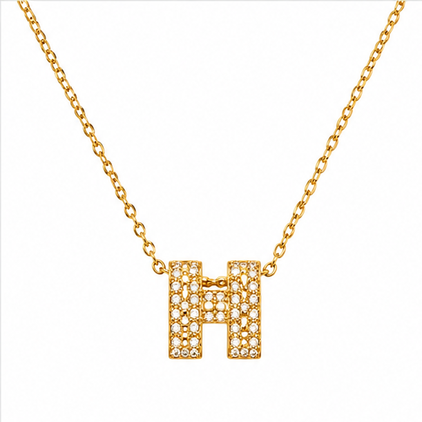 Luxury gold plated stainless steel letter H initial pendant necklace entirely paved with clear shimmering crystal zircons on a plain white background