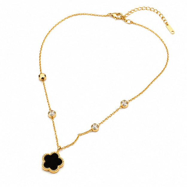 Full layout overview of a gold clover necklace showing the entire chain structure, secure lobster clasp closure, and extender link loop.