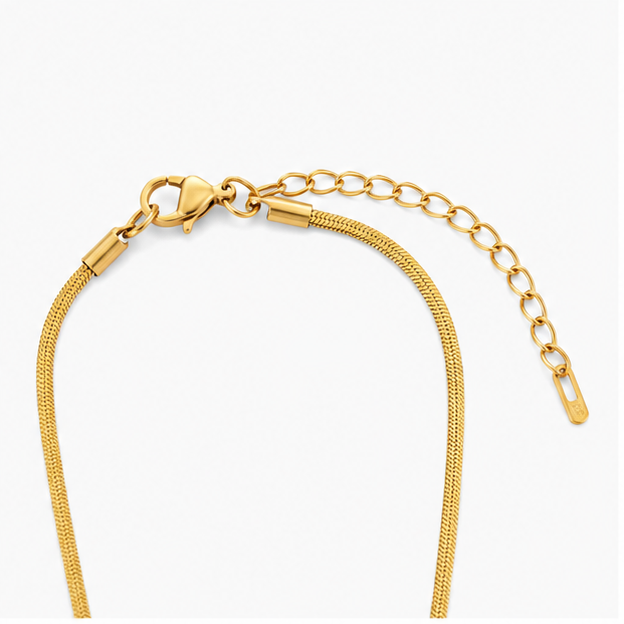 Close-up macro view of the gold lobster clasp closure and adjustable extender link chain on Zafiroon stainless steel jewelry.
