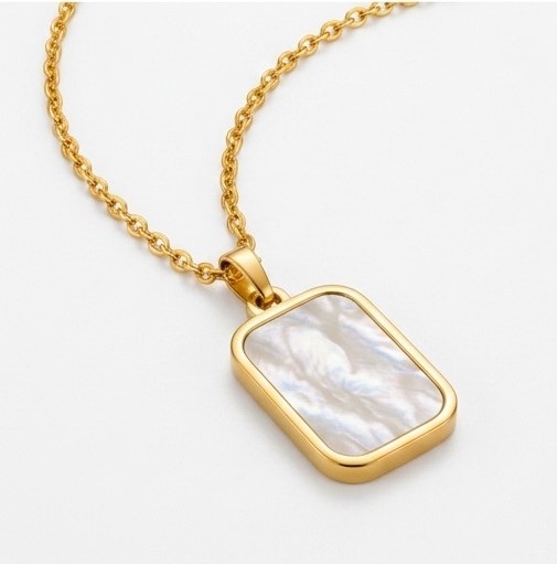 Angled side view of Zafiroon gold rectangle pendant necklace showing the thickness of the bezel setting and delicate cable chain on a white background.