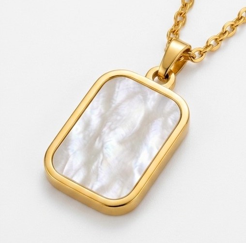 Macro close-up shot of Zafiroon rectangular gold pendant emphasizing the natural organic texture and white swirl patterns of the mother of pearl inlay.