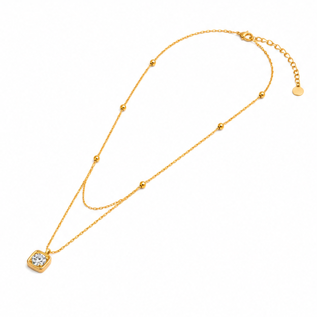 Left angled showcase of a tarnish free gold multi layer necklace with delicate satellite ball chain links on a white background.