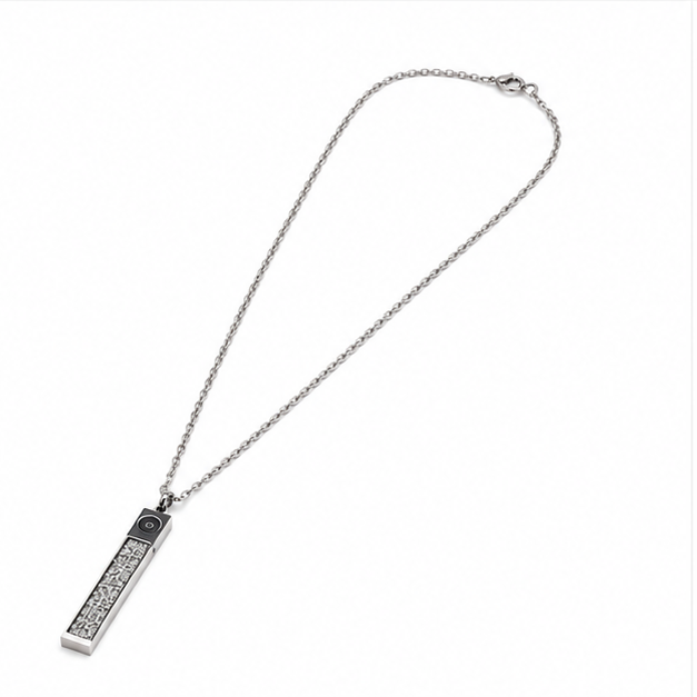 High angle left perspective of a silver stainless steel vertical bar pendant necklace with textured black inlay.