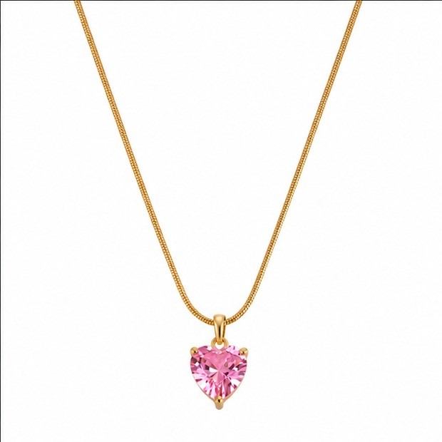 Gold plated stainless steel fine snake chain necklace featuring a central hanging faceted translucent pink crystal heart shaped pendant charm on a white background