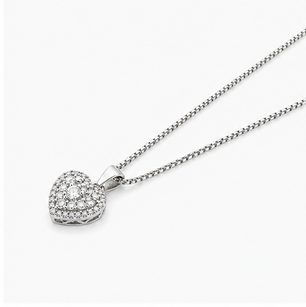Right angled macro view of a silver heart shaped diamond pendant necklace with intricate side basket wirework.