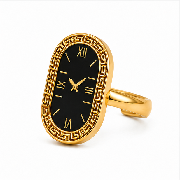 High-end gold plated stainless steel oval statement ring displaying a vintage black watch dial motif with Roman numerals and an engraved Greek key border pattern on a white background
