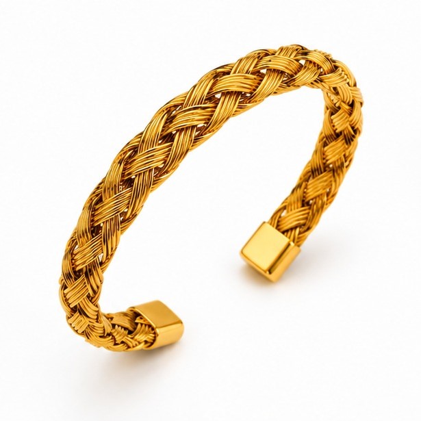Dynamic three-quarter studio perspective view of the open-ended gold woven mesh bracelet resting on a plain white background.