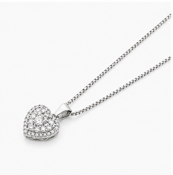 Low angle studio perspective of a silver chain necklace attached to a shimmering crystal love heart charm.