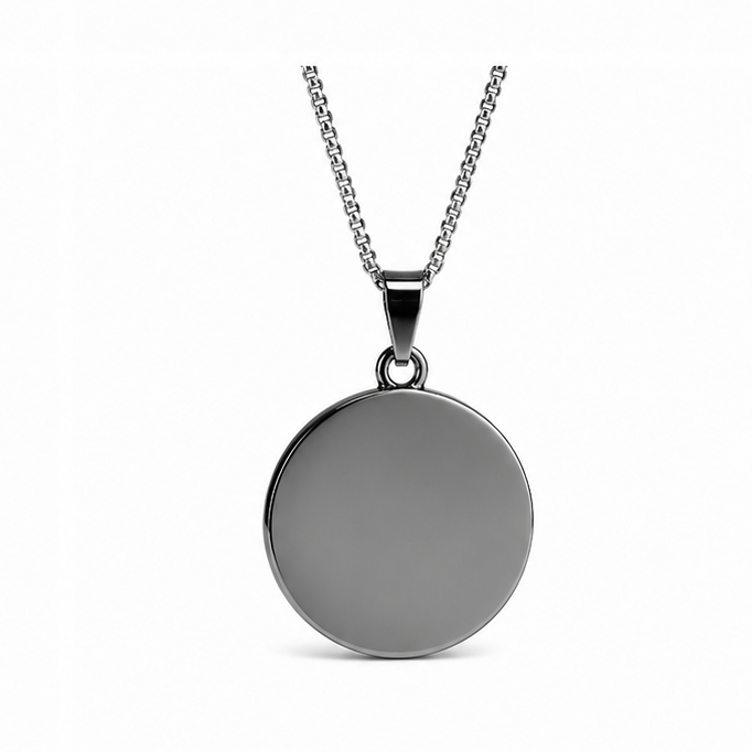 Back view of a smooth polished blank circular black steel pendant highlighting a customized engraving surface area.