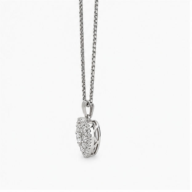 Side view of a silver pave heart pendant necklace displaying the depth and hollow geometric lattice casing architecture.